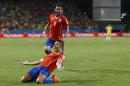Chile's Mauricio Isla (4) watches as Alexis Sanchez celebrates after scoring his side's first goal during the first half of the group B World Cup soccer match between Chile and Australia in the Arena Pantanal in Cuiaba, Brazil, Friday, June 13, 2014. (AP Photo/Kirsty Wigglesworth)