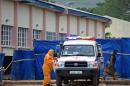A patient (R) arrives by ambulance on November 11, 2014 at the Hastings treatment centre, outside Freetown