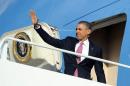 US President Barack Obama boards Air Force One at Andrews Air Force Base in Maryland on November 24, 2013 en route to Seattle, Washington