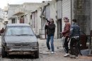Free Syrian Army fighters are seen at a front line during fighting with Syrian forces loyal to President Assad at Bustan al-Qasr district