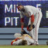 Washington Nationals right fielder Byrce Harper lies on the field as center fielder Denard Span looks over him after Harper hit the wall chasing a triple off the Los Angeles Dodgers' A.J. Ellis in the fifth inning of a baseball game in Los Angeles Monday, May 13, 2013. (AP Photo/Reed Saxon)