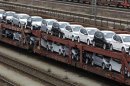 New cars by German car manufacturer Volkswagen stand on wagons at train station in Munich
