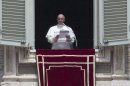Pope Francis reads a message during the Angelus noon prayer he celebrated from the window of his studio overlooking St. Peter's square at the Vatican, Sunday, June 9, 2013.(AP Photo/Alessandra Tarantino)