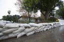 Sandbags and cement barriers are pictured as rain begins to fall in Glendora, California