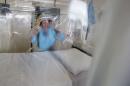File photograph shows senior Matron Breda Athan demonstrates putting on the protective suit which would be used if it becomes necessary to treat patients suffering from Ebola, at The Royal Free Hospital in London