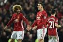 Manchester United's striker Zlatan Ibrahimovic (C) celebrates scoring his team's first goal with midfielder Marouane Fellaini (L) during the English Premier League football match against Liverpool January 15, 2017