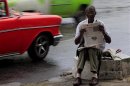 A man sells newspapers on a street in Havana