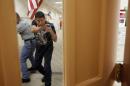 Sgt. Andres Vega, a Corpus Christi Independent School District police officer from Moody High School, prepares to enter a classroom room with a mock shooter inside during an active shooter training exercise Tuesday, Aug. 19, 2014, at the old Lamar Elementary in Corpus Christi, Texas, Officer's with the district's police department go through active shooter simulations before each school year. (AP Photo/Corpus Christi Caller-Times, Michael Zamora) MANDATORY CREDIT; MAGS OUT; TV OUT