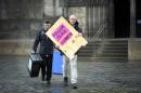 Polling Manager Scott Russel (R) and assistant Ross Clement deliver ballot boxes and a polling sign to a polling station on The Royal Mile in the centre of Edinburgh on May 6, 2015 on the eve of the General election