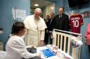 In this picture provided by the Vatican newspaper L'Osservatore Romano, Pope Francis speaks with patient Giorgia, no last name available, at the Bambino Gesu' pediatric hospital, in Rome, Saturday, Dec. 21, 2013. Francis spent three hours visiting patients and their families and is the fifth pontiff to visit the hospital, which is controlled by the Vatican's secretary of state. (AP Photo/L'Osservatore Romano, ho)