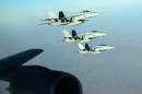 In this Tuesday, Sept. 23, 2014 photo released by the U.S. Air Force, a formation of U.S. Navy F-18E Super Hornets leaves after receiving fuel from a KC-135 Stratotanker over northern Iraq as part of U.S. led coalition airstrikes on the Islamic State group and other targets in Syria. U.S.-led airstrikes targeted Syrian oil installations held by the militant Islamic State group overnight and early Thursday, Sept. 25, 2014, killing nearly 20 people as the militants released dozens of detainees in their de facto capital, fearing further raids, activists said. (AP Photo/U.S. Air Force, Staff Sgt. Shawn Nickel)