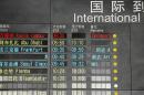 The arrival board at the International Airport in Beijing, China shows a Malaysian airliner is delayed, Saturday, March 8, 2014. A Malaysia Airlines Boeing 777-200 carrying 239 people lost contact with air traffic control early Saturday morning on a flight from Kuala Lumpur to Beijing, and international aviation authorities still hadn't located the jetliner several hours later. (AP Photo/Ng Han Guan)