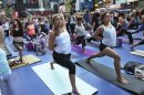 People practice yoga on the morning of the summer solstice in New York's Times Square June 20, 2012. REUTERS/Shannon Stapleton