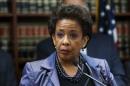 United States Attorney Loretta E. Lynch speaks during an announcement of the arrest of Abraxas J. ("A.J.") Discala, CEO of OmniView Capital, and six co-conspirators for fraudulent market manipulation at the U.S. Attorney's office in Brooklyn, New York