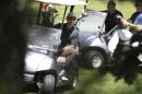 President Barack Obama, left, maneuvers his golf cart while golfing at Farm Neck Golf Club, in Oak Bluffs, Mass., on the island of Martha's Vineyard, Thursday, Aug. 21, 2014. Obama is vacationing on the island. (AP Photo/Steven Senne)