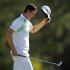 Justin Rose of England tips his hat after sinking a birdie putt on the 18th green during second round play in the 2013 Masters golf tournament in Augusta
