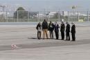 French President Hollande walks with former French hostages on the tarmac upon their arrival at Villacoublay military airport in Villacoublay