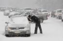 A Highway Patrol officer checks on the safety of a stranded motorist on Hammond Road during a winter storm Wednesday Feb. 12, 2014, in Durham, N.C. (AP Photo/The News & Observer, Travis Long) MANDATORY CREDIT
