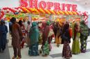 Shoppers stand outside the main entrance of the new Shoprite outlet in Kano, northern Nigeria, on March 20, 2014