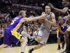 San Antonio Spurs' Manu Ginobili, center, of Argentina, drives between Los Angeles Lakers' Steve Blake, left, and Dwight Howard during the second half of Game 1 of their first-round NBA basketball playoff series, Sunday, April 21, 2013, in San Antonio. San Antonio won 91-79. (AP Photo/Eric Gay)