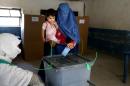An Afghan woman casts her vote at a polling station in Jalalabad, east of Kabul, Afghanistan, Saturday, June 14, 2014. Despite Taliban threats of violence, many Afghans vow to cast ballots in Saturday's presidential runoff vote with hopes that whoever replaces Hamid Karzai will be able to provide security and stability after international forces wind down their combat mission at the end of this year. (AP Photo/Rahmat Gul)