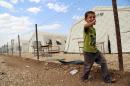 A Yazidi boy from Iraq walks at a refugee camp in the Kurdish town of Derik, Syria, on the border with Turkey and Iraq on September 16, 2015