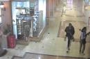 In this frame grab from surveillance video provided by Kenya Police via KTN, two gunmen wander through the Westgate Mall, Sept. 21, 2013, in Nairobi, Kenya. Several attackers from the Somali militant group al-Shabab stormed the mall on Sept. 21, killing at least 67 people during a four-day siege. (AP Photo/Kenya Police via KTN)