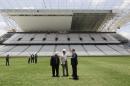 FILE - In this Jan. 20, 2014 file photo, Jerome Valcke, secretary general of FIFA, right center, and Aldo Rebelo, Brazil's sports minister, center, inspect the Sao Paulo stadium, in Sao Paulo, Brazil. The stadium which hosts the opening match of the World Cup will not be finished until less than four weeks before Brazil plays Croatia on June 12. Confirming further delays Saturday, March 1, 2014, Valcke said the venue would not be ready before May 15. (AP Photo/Nelson Antoine, File)