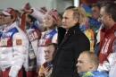 Russia's President Putin attends a ceremony to raise the Russian flag as he visits the mountain village on the eve of the opening of the 2014 Sochi Paralympic Winter Games in Krasnaya Polyana