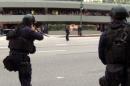 In this July 6, 2013 still frame from a video produced by the Los Angeles Police Department, officers fire on a woman posing as a terrorist in a drill simulating a terrorist attack in downtown Los Angeles. After spending a decade sending military equipment to civilian police departments across the United States, Washington is reconsidering the idea in light of the violence in Ferguson, Mo., amid images of heavily-armed police, snipers trained on protesters and tear gas plumes. One night after the violence that accompanied the presence of military-style equipment in Ferguson, the crowd calmed considerably when a police captain walked through the crowd, unprotected, in a gesture of reconciliation. The contrast added to the perception that the tanks and tear gas had done more harm than good. (AP Photo/Los Angeles Police Department)