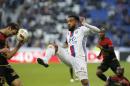 Lyon's Alexandre Lacazette, center, challenges for the ball with Guingamp's Christophe Kerbrat, left, during their French League One soccer match in Decines, near Lyon, central France, Saturday, Oct. 22, 2016. (AP Photo/Laurent Cipriani)