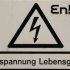 A sign under the logo of German energy provider "EnBW" reads "high voltage - life dangerous", on a power line post next to the nuclear power plant in Phillipsburg