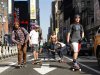 Skateboarders pass Times Square while they take part in a race on the streets in New York