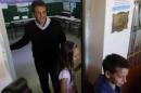 Massa accompanied by his children Milagros and Tomas (R) prepares to vote for the legislative election in Tigre