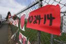 A sign bearing the Oct. 24, 2014 date of a shooting in the cafeteria of Marysville Pilchuck High School is shown Monday, Oct. 27, 2014 as part of a growing memorial on a fence around the school in Marysville, Wash. (AP Photo/Ted S. Warren)
