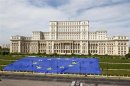 A large European Union flag is displayed in front of Romania's Parliament Building to mark EU Day in Bucharest