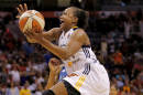 FILE - In this July 19, 2014, file photo, East's Tamika Catchings, of the Indiana Fever, scores the game winning basket during the overtime period of the WNBA All-Star basketball game in Phoenix. Three-time Olympic gold medalist Tamika Catchings says she will retire after the 2016 Rio Games. The Indiana Fever star confirmed Friday, Oct. 3, 2014, in an email to The Associated Press that she will call it quits after the 2016 Olympics, but plans to play two more WNBA seasons. (AP Photo/Matt York, File)