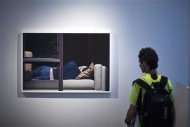 A man attends a photo exhibition called 'The Neighbors" by fine art photographer Arne Svenson at Julie Saul Gallery in New York in this June 1, 2013 file photo. Svenson, who secretly used a zoom lens to photograph his neighbors napping and eating has caused a citywide stir -- and two legal actions so far. REUTERS/Eduardo Munoz/Files