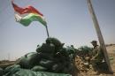 A Kurdish Peshmerga fighter guards a checkpoint in the northern Iraqi village of Bashir, on June 21, 2014