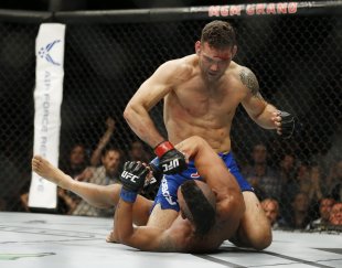 Chris Weidman pounds Vitor Belfort during their UFC 187 fight. (AP)