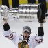 Chicago Blackhawks' Jonathan Toews hoists the Stanley Cup after defeating the Boston Bruins 3-2 in Game 6 to win the NHL hockey Stanley Cup Finals, Monday, June 24, 2013, in Boston. (AP Photo/Charles Krupa)
