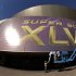 In this photo taken with a fisheye lens, workers put up signage outside the Superdome where tomorrow's NFL Super Bowl XLVII football game between the San Francisco 49ers and Baltimore Ravens will be played, Saturday, Feb. 2, 2013, in New Orleans. (AP Photo/Charlie Riedel)