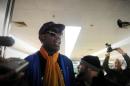 Former US basketball player Dennis Rodman (C) talks to the media upon arriving at Beijing International Airport from North Korea on January 13, 2014