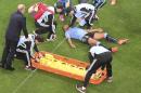 Uruguay's Alvaro Pereira is put on a stretcher during the group D World Cup soccer match between Uruguay and England at the Itaquerao Stadium in Sao Paulo, Brazil, Thursday, June 19, 2014. (AP Photo/Francois Xavier Marit, pool)