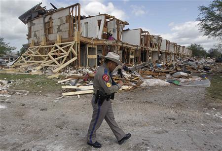 Texas Department of Public Safety Sergeant Jason Reyes walks past the site of a housing complex which was destroyed by a deadly fertilizer plant explosion in the town of West, near Waco, Texas April 21, 2013. REUTERS/Michael Ainsworth/Pool