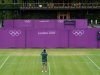 A workman takes a photograph on Court 10 as Olympic hoarding is erected at the All England Lawn Tennis Club as preparations are made for the London 2012 Olympic Games, in London