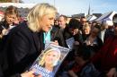 French far-right party leader Marine Le Pen meets residents in a marketplace, in Douai, northern France, as part of the municipal campaign, Saturday, Nov. 7, 2015. Regional elections are taking place next month in which the far right National Front is hoping to increase its political power, in part by capitalizing on tensions over waves of migrants in Europe this year. The first round of the regional elections will take place on Dec. 6, 2015. (AP Photo/Michel Spingler)