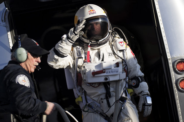 In this photo provided by Red Bull Stratos, Felix Baumgartner salutes as he prepares to board the capsule carried by a balloon during the first manned test flight for Red Bull Stratos in Roswell, N.M. on Thursday, March 15, 2012. Baumgartner is more than halfway toward his goal of setting a world record for the highest jump. A spokesperson says the skydiver took a practice jump from more than 13 miles high over New Mexico. He's aiming for nearly 23 miles in the summer. The record is held by Joe Kittinger who jumped from 19.5 miles in 1960. (AP Photo/Red Bull Stratos, Joerg Mitter)