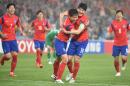 Kim Young Gwon of South Korea (C-R) celebrates scoring their second goal with teammate Ki sung Yueng (C-L) against Iraq during the AFC Asian Cup semi-final football match in Sydney on January 26, 2015