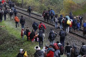 Migrants walk on train tracks after leaving a camp&nbsp;&hellip;
